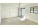 Bedroom with carpet, double door closet and sliding door at 2105 Lake Bentley Ct, Lakeland, FL 33803