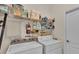 Laundry room with washer, dryer, and ample storage shelves at 240 Burford Cir, Davenport, FL 33896