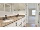 Double vanity bathroom with granite countertop and view to bedroom at 425 E Belmar St, Lakeland, FL 33803
