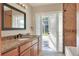 Bathroom with granite vanity, glass block feature and pool access at 425 E Belmar St, Lakeland, FL 33803