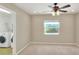 Well-lit bedroom featuring a ceiling fan and access to laundry at 425 E Belmar St, Lakeland, FL 33803