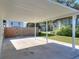 Covered carport with concrete parking area and fenced backyard at 425 E Belmar St, Lakeland, FL 33803