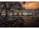 Charming bungalow with a white exterior, manicured lawn, and brick driveway at 425 E Belmar St, Lakeland, FL 33803