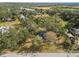 Aerial view showing the house's location on a large lot with trees at 4925 Magnolia Ave, Mulberry, FL 33860