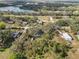 Aerial view of property showing home, shed, and expansive lot with lake nearby at 4925 Magnolia Ave, Mulberry, FL 33860