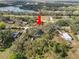 Aerial view showcasing the house and its location near a lake and road at 4925 Magnolia Ave, Mulberry, FL 33860