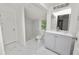 Modern bathroom with marble-tiled shower, vanity, and toilet at 4925 Magnolia Ave, Mulberry, FL 33860
