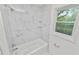 Newly renovated bathroom featuring marble shower and white vanity at 4925 Magnolia Ave, Mulberry, FL 33860