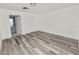 Spacious bedroom with vinyl plank flooring and access to a full bathroom at 4925 Magnolia Ave, Mulberry, FL 33860