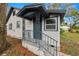 House exterior showcasing a front porch and steps with an ornate railing at 4925 Magnolia Ave, Mulberry, FL 33860