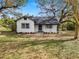 Charming white house with dark gray roof and well-maintained lawn at 4925 Magnolia Ave, Mulberry, FL 33860