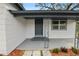Inviting front porch with a dark gray door and ornate metal railings at 4925 Magnolia Ave, Mulberry, FL 33860