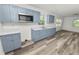 Renovated kitchen with light blue cabinets, quartz countertops, and stainless steel appliances at 4925 Magnolia Ave, Mulberry, FL 33860