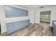 Updated kitchen boasts light blue cabinets, white quartz countertops, and new flooring at 4925 Magnolia Ave, Mulberry, FL 33860