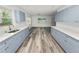 Updated kitchen featuring gray cabinets, quartz countertops, and stainless steel appliances at 4925 Magnolia Ave, Mulberry, FL 33860