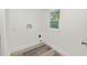 Laundry room with wood-look floors and hookups for a washer and dryer at 4925 Magnolia Ave, Mulberry, FL 33860