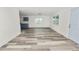 Spacious living area with vinyl flooring and a view into the kitchen at 4925 Magnolia Ave, Mulberry, FL 33860