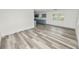 Open living room with wood-look flooring and kitchen access at 4925 Magnolia Ave, Mulberry, FL 33860
