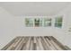 Sunroom featuring wood-look floors and multiple windows at 4925 Magnolia Ave, Mulberry, FL 33860