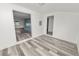 Bright sunroom addition with wood-paneled walls and vinyl plank flooring at 4925 Magnolia Ave, Mulberry, FL 33860