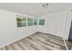 Sunroom features wood-paneled walls, vinyl flooring, and access to the outdoors at 4925 Magnolia Ave, Mulberry, FL 33860