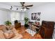 Cozy living room boasts hardwood floors, a ceiling fan, and vintage accents at 5029 Forestgreen E Dr, Lakeland, FL 33811