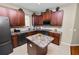 Spacious kitchen with an island, dark wood cabinets, and stainless steel appliances at 5548 Huron Way, Lakeland, FL 33805