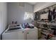 Washer, dryer, and storage shelves in a functional laundry room at 806 Lafayette Ln, Lakeland, FL 33805