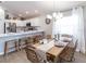 Bright dining room with a wooden table and stylish decor, adjacent to the kitchen at 1839 Daystar Dr, Haines City, FL 33844
