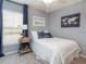 Cozy bedroom with a twin-size bed, nightstand, and nautical-themed decor at 1843 Daystar Dr, Haines City, FL 33844