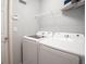 Bright laundry room with Samsung washer and dryer, wire shelving and white walls at 1843 Daystar Dr, Haines City, FL 33844