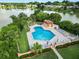 Community pool and patio area, lush landscaping, lake view at 2055 S Floral Ave # 146, Bartow, FL 33830