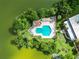 Community pool and surrounding landscape with lake view at 2055 S Floral Ave # 146, Bartow, FL 33830