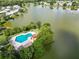 Community pool and surrounding landscape with lake view at 2055 S Floral Ave # 146, Bartow, FL 33830