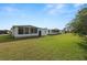 Large backyard with green grass and mobile homes at 2055 S Floral Ave # 146, Bartow, FL 33830