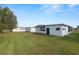 Spacious backyard with green grass and mobile homes at 2055 S Floral Ave # 146, Bartow, FL 33830