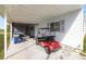 Covered carport with golf cart and storage at 2055 S Floral Ave # 146, Bartow, FL 33830
