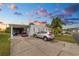 Mobile home with carport, golf cart, and driveway at 2055 S Floral Ave # 146, Bartow, FL 33830