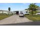 Mobile home with carport, golf cart, and driveway at 2055 S Floral Ave # 146, Bartow, FL 33830