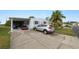 Mobile home with carport, golf cart, and driveway at 2055 S Floral Ave # 146, Bartow, FL 33830