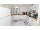 Kitchen with white cabinets, appliances, and wood flooring at 2055 S Floral Ave # 146, Bartow, FL 33830