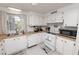 Kitchen with white cabinets, appliances, and wood flooring at 2055 S Floral Ave # 146, Bartow, FL 33830