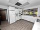 Community kitchen with white appliances and cabinets at 2055 S Floral Ave # 146, Bartow, FL 33830