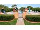 Community pool with gate entry and surrounding landscaping at 2055 S Floral Ave # 146, Bartow, FL 33830