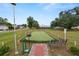 Community putting green with a brick pathway and bench at 2055 S Floral Ave # 146, Bartow, FL 33830