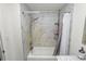 Clean bathroom featuring marble tile shower and tub at 210 Wilder Rd, Lakeland, FL 33809