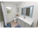 Bathroom with light grey vanity and a large mirror at 210 Wilder Rd, Lakeland, FL 33809