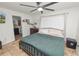 Main bedroom with king bed, en-suite bathroom access, and ample closet space at 210 Wilder Rd, Lakeland, FL 33809