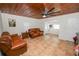 Living room with wood ceiling, tile floors, and leather couches at 210 Wilder Rd, Lakeland, FL 33809