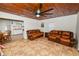 Living room with wood-paneled ceiling and leather sofas at 210 Wilder Rd, Lakeland, FL 33809